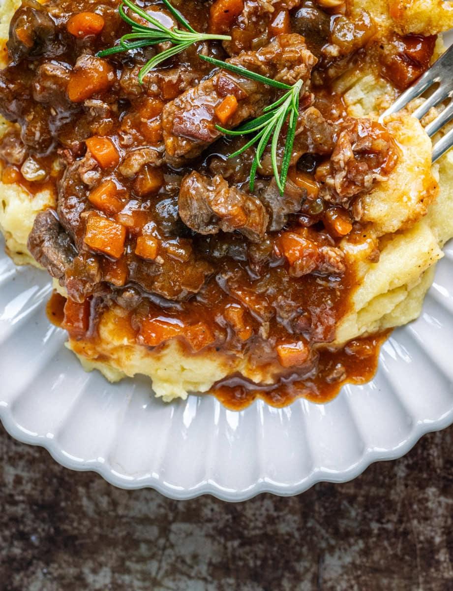 spezzatino di manzo served over soft polenta (close up)