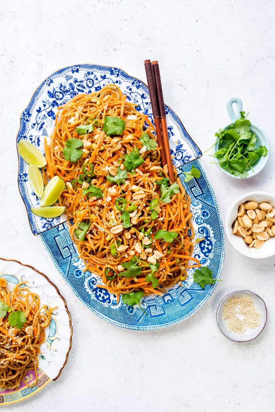platter of spicy peanut noodles with carrot and coriander