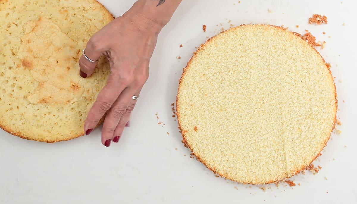 splitting a sponge cake in half using a leveler