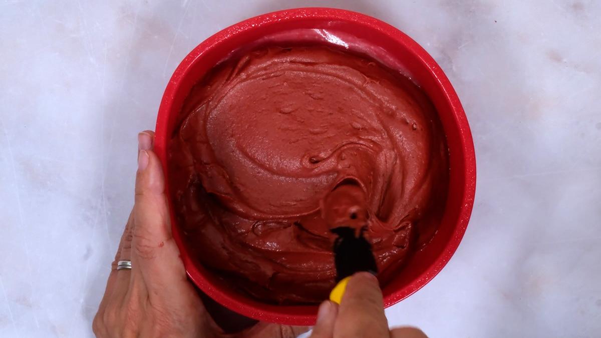 spreading cake batter in a cake tin