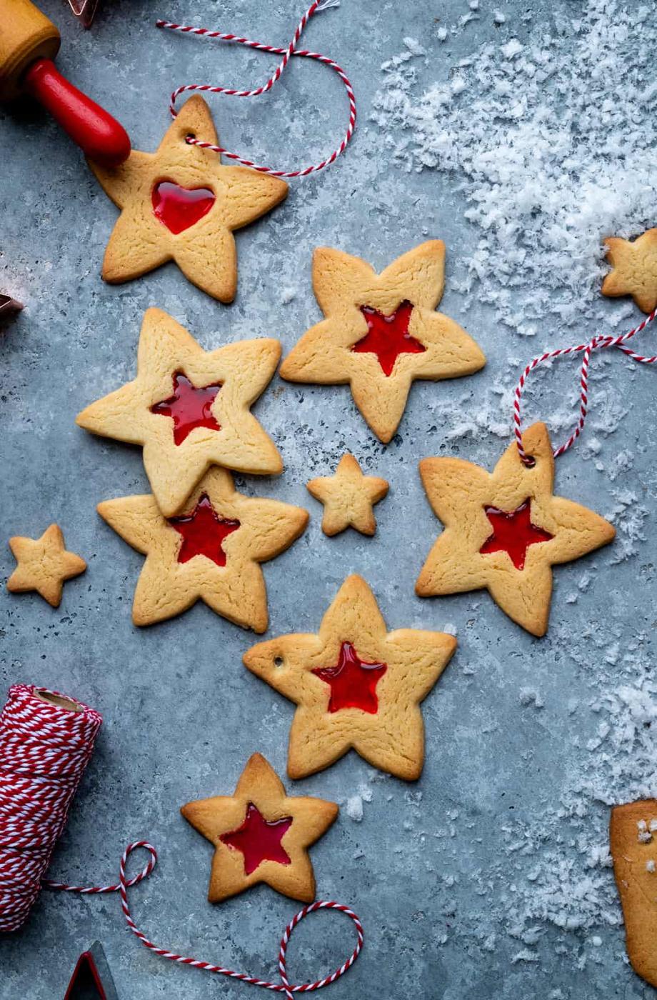 Star shaped stained glass window cookies on a blue background