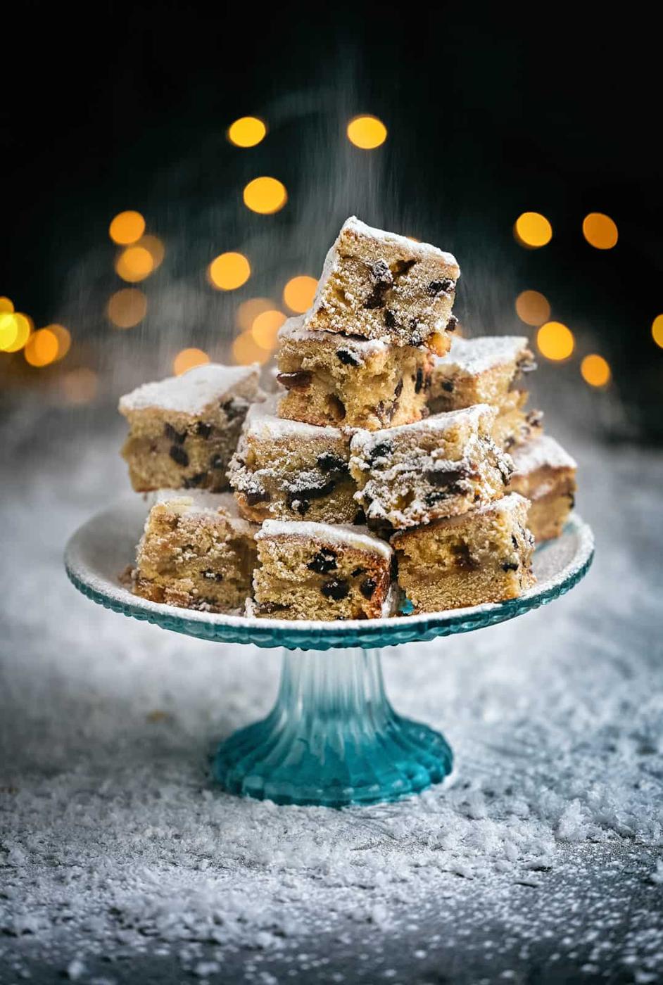 Stollen bites dusted with icing sugarpiled on a cake stand
