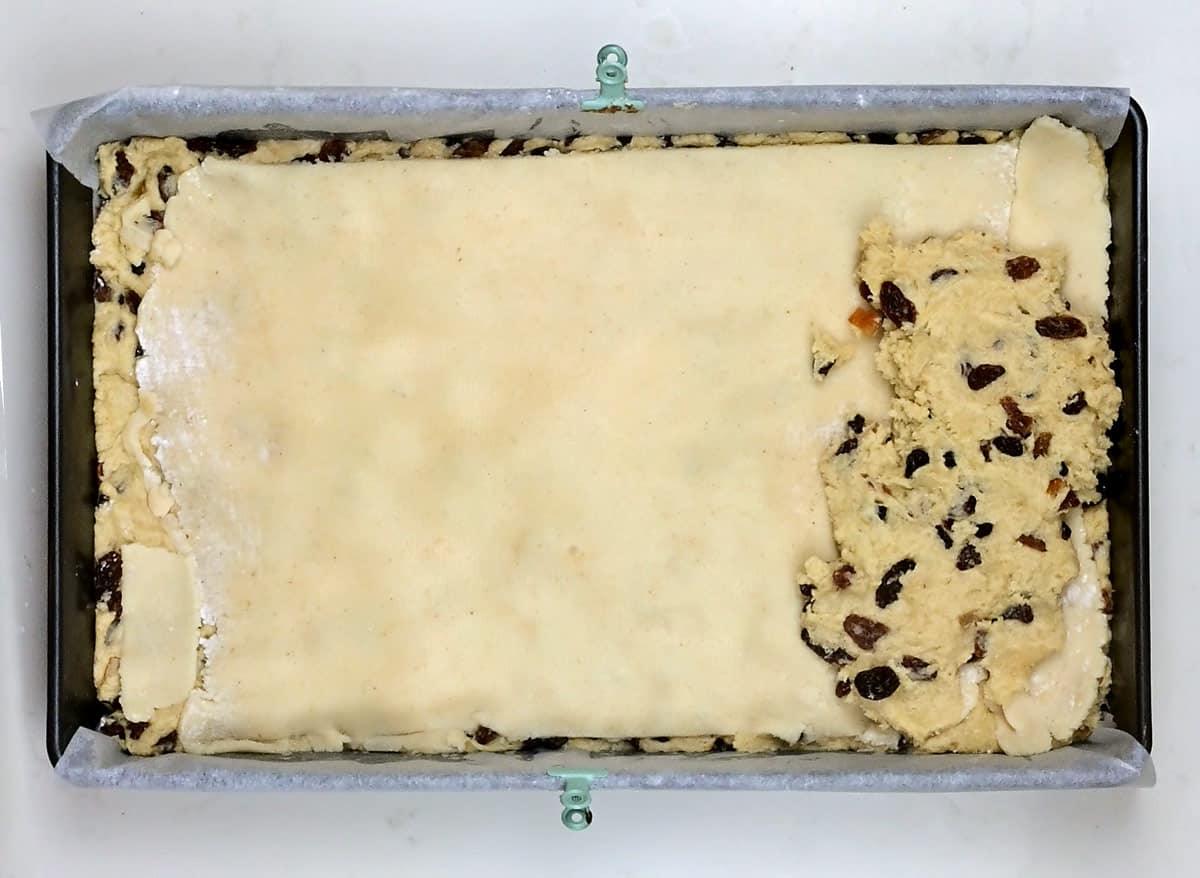 Topping stollen dough with rolled out marzipan