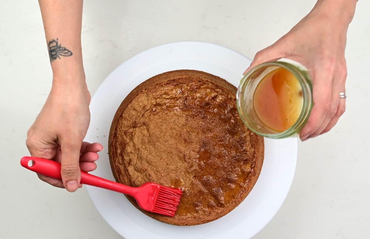 brushing cake with vodka and passion fruit liqueur