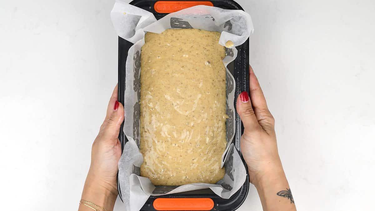 Banana bread batter in loaf tin ready for the oven