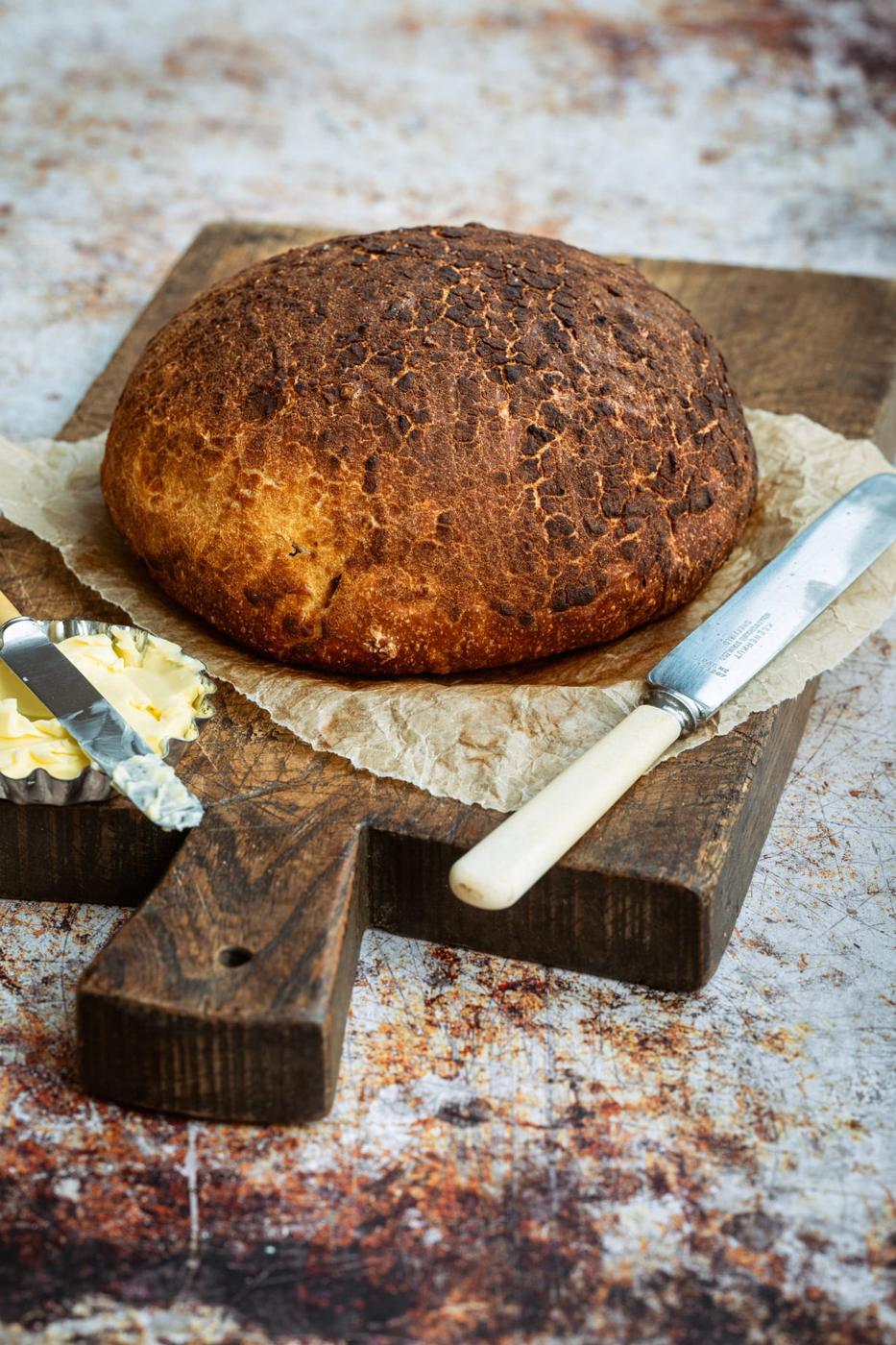 Loaf of homemade Tiger Bread on a cutting board