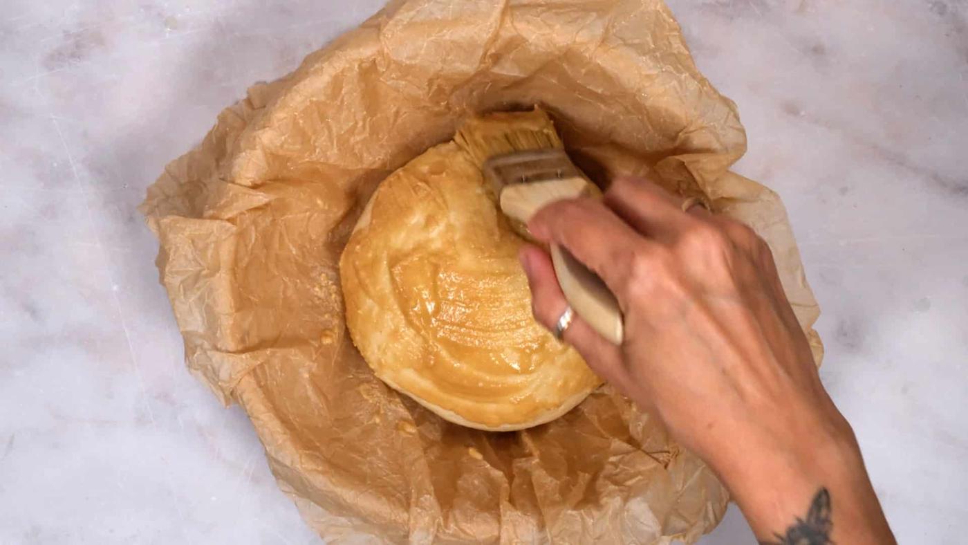 brushing paste over bread dough to make Dutch Tiger Bread