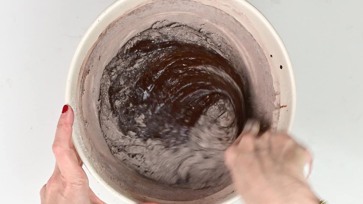 stirring flour into brownie batter