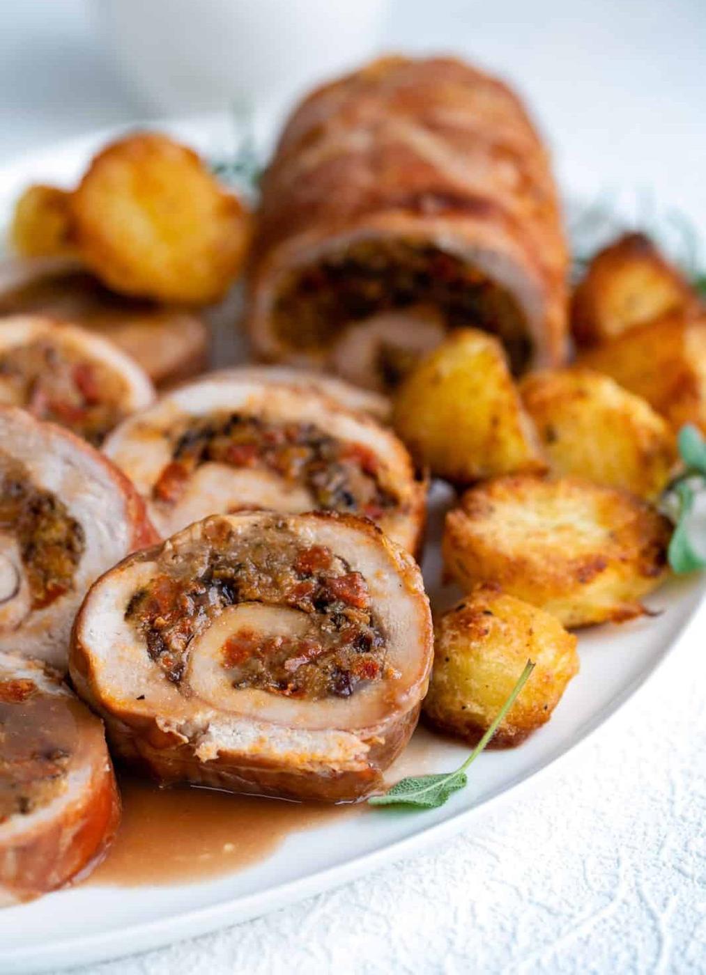 Slices of stuffed turkey breast arranged on a platter