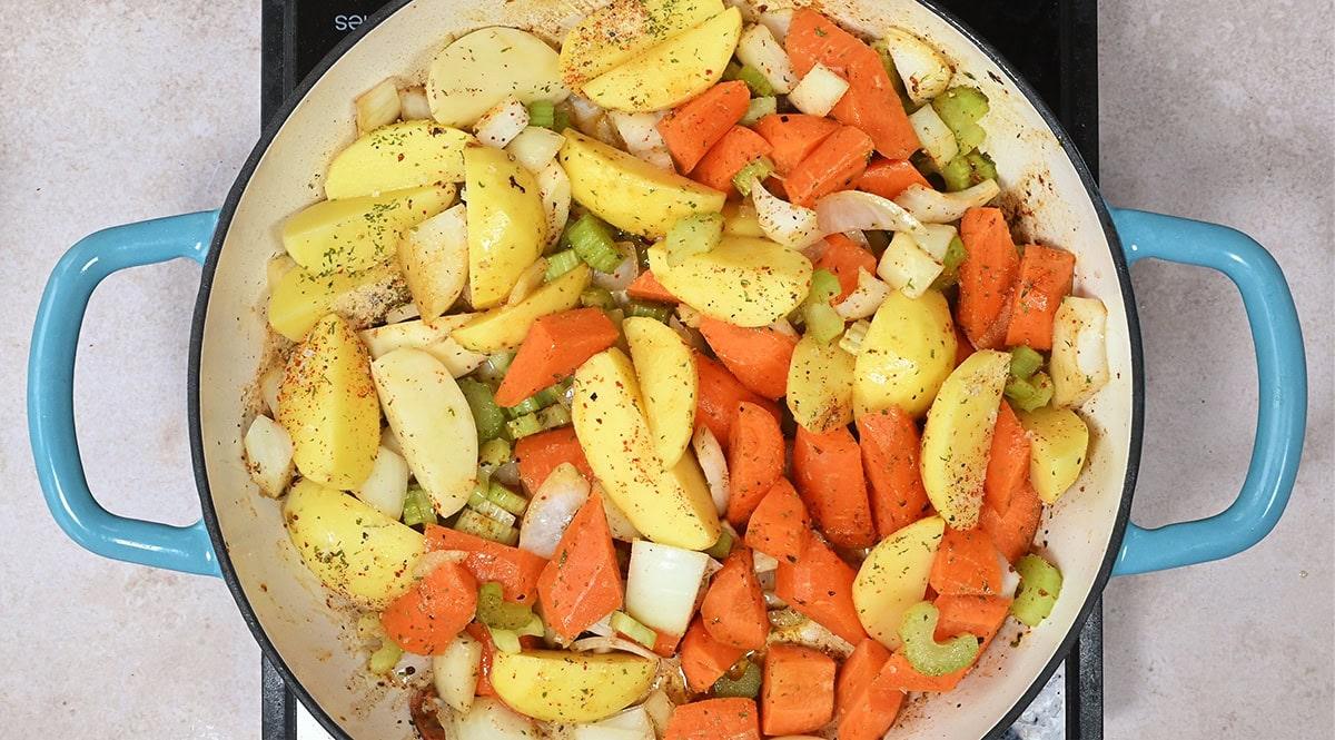 onion, carrots, celery and potatoes in a shallow casserole