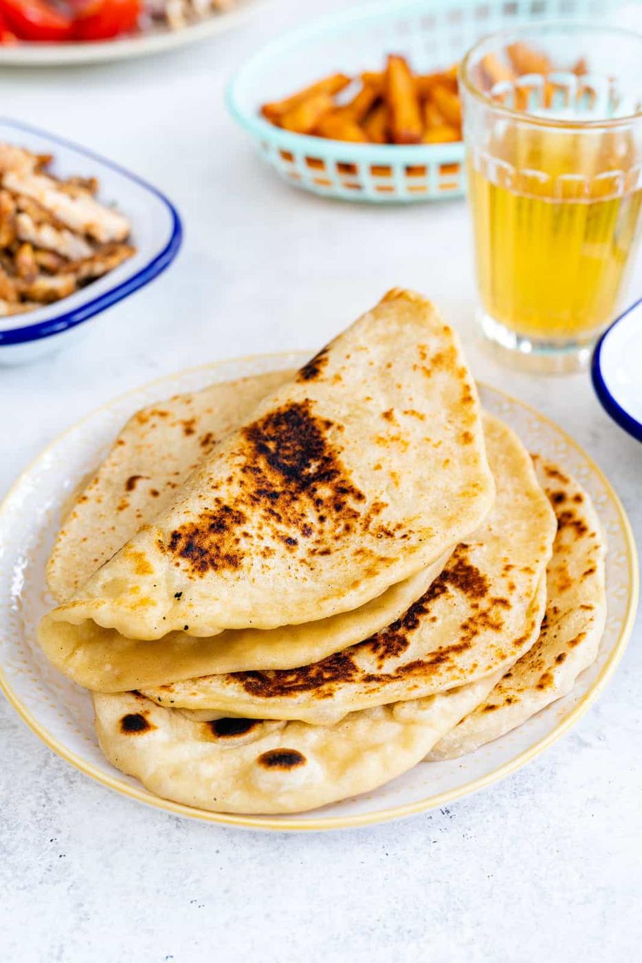 soft flatbreads stacked on a plate