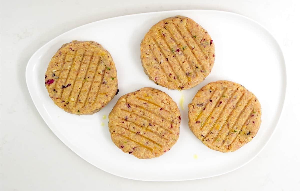 Four turkey patties on a platter