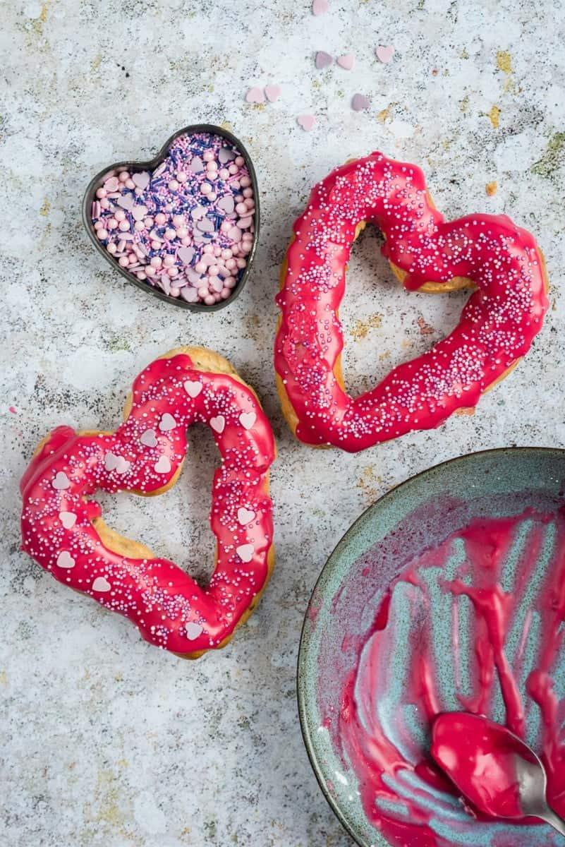 Heart-shaped chocolate eclairs with berry glaze