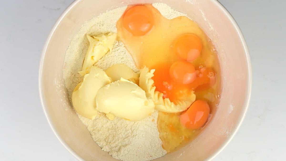 Ingredients for orange cake in a mixing bowl
