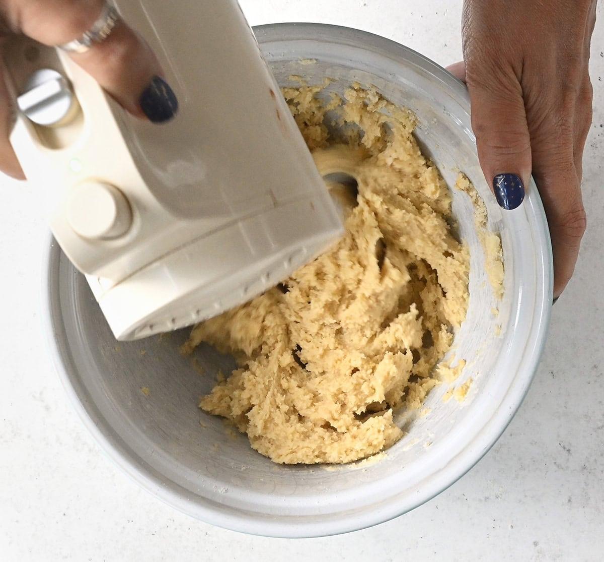 making vanilla cookie dough with a hand mixer