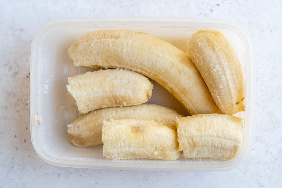 Frozen bananas in a plastic container