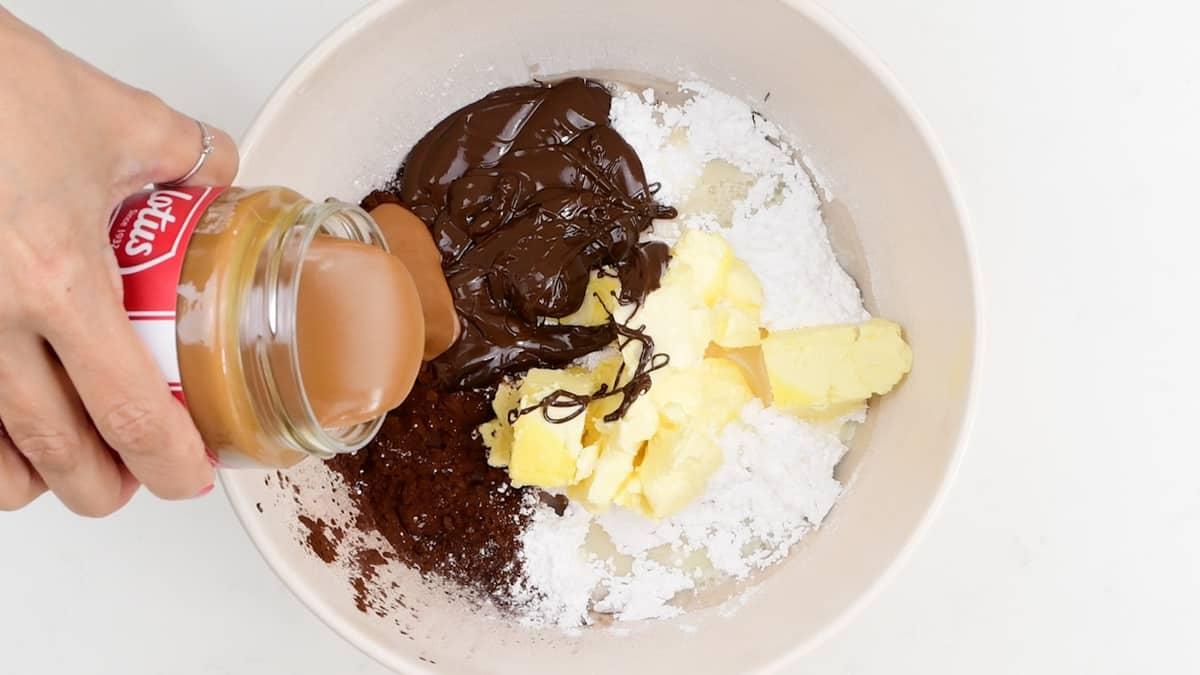 preparing Biscoff frosting in a mixing bowl