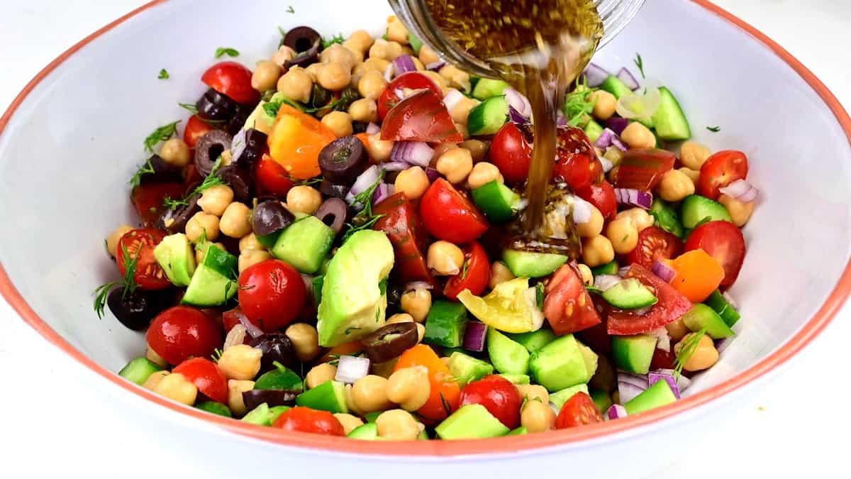 Adding dressing to chickpea salad
