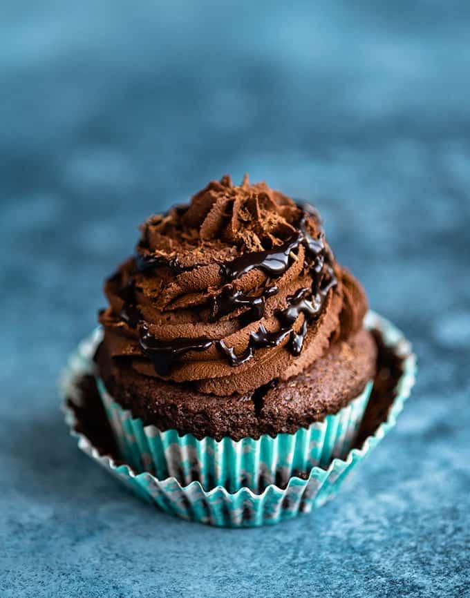 Vegan chocolate cupcake topped with ganache frosting and chocolate sauce