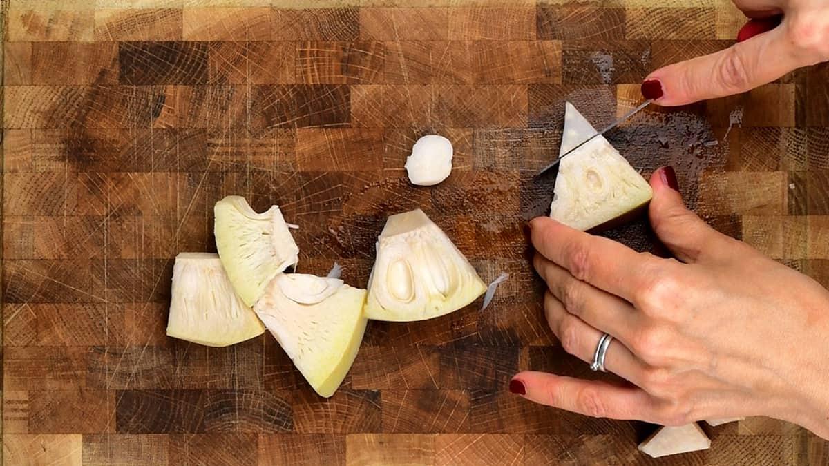 slicing the tough end of canned jackfruit before cooking