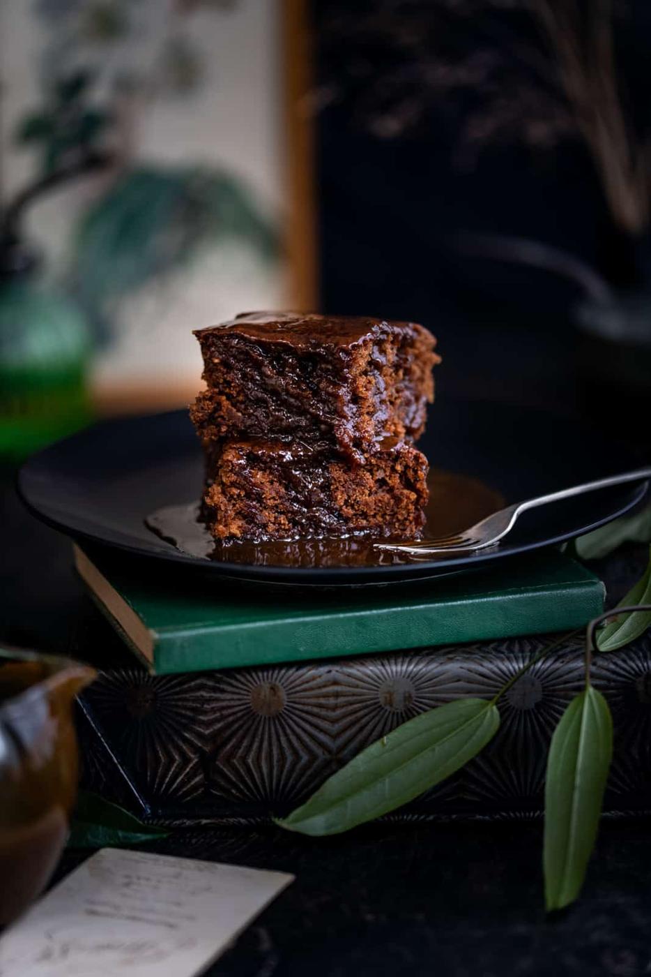 Vegan sticky toffee cake on a black plate
