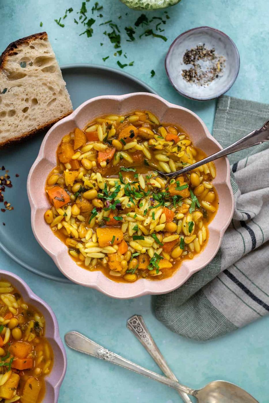 Overhead view of scalloped bowl of vegetarian orzo soup