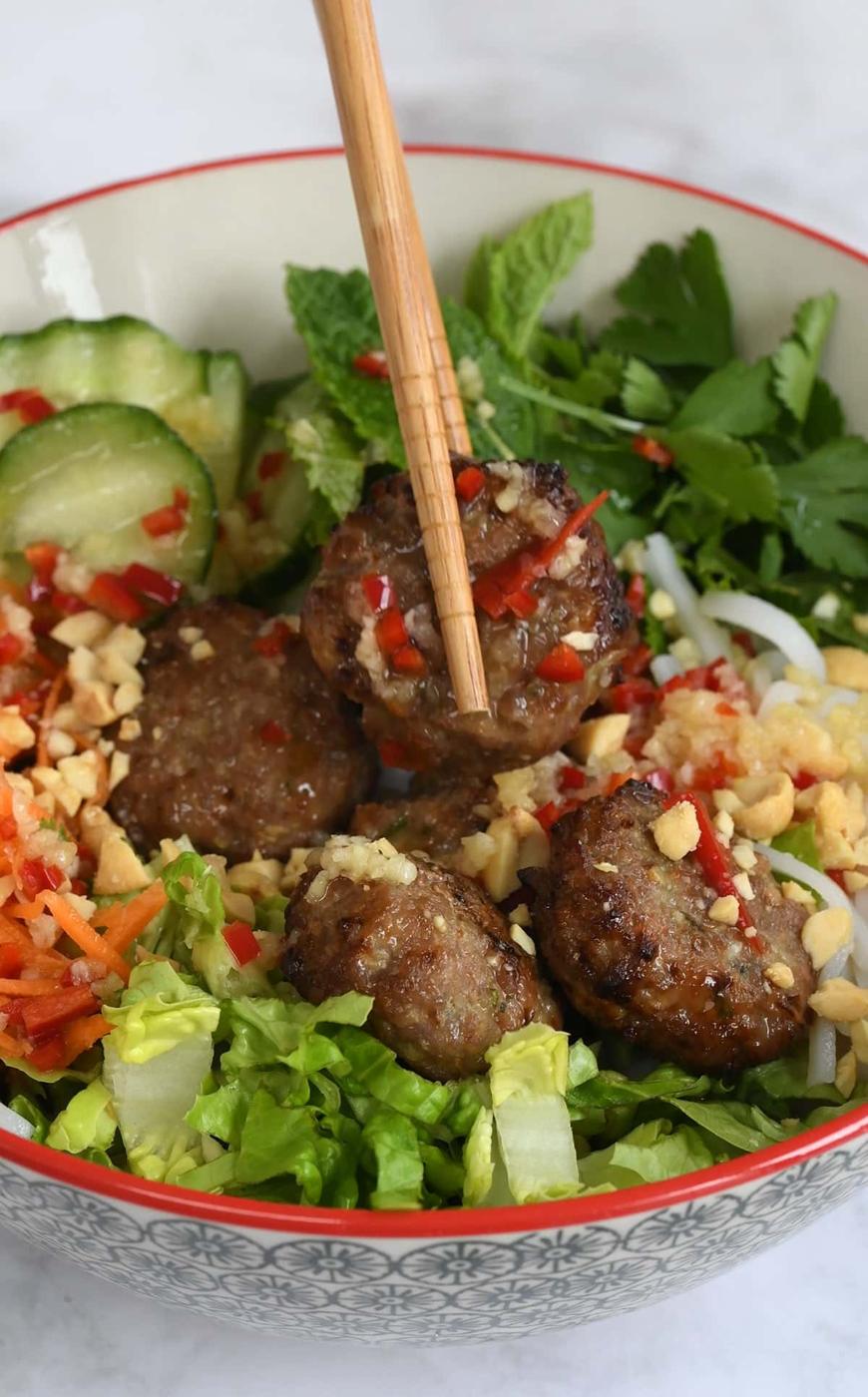 vietnamese pork meatballs (bun cha) in a bowl with noodles and vegetables