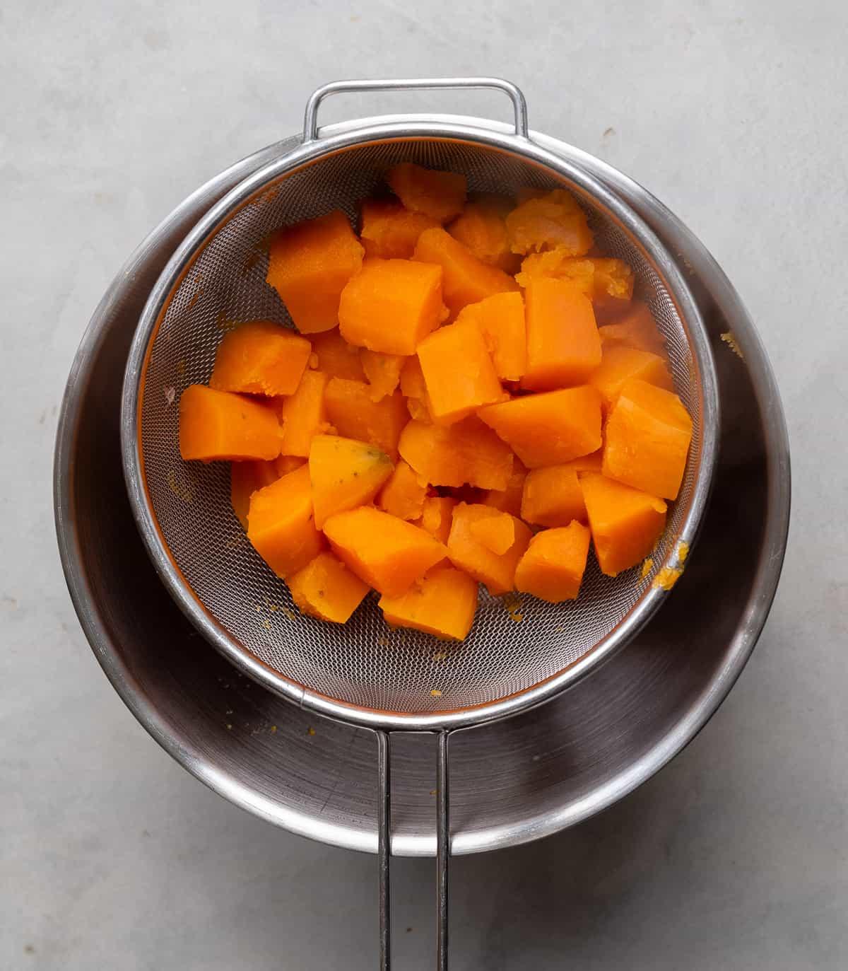 cooked sweet potatoes in a sieve