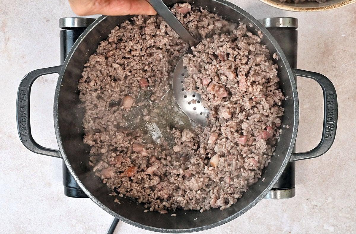 browning ground beef and pork in a pot