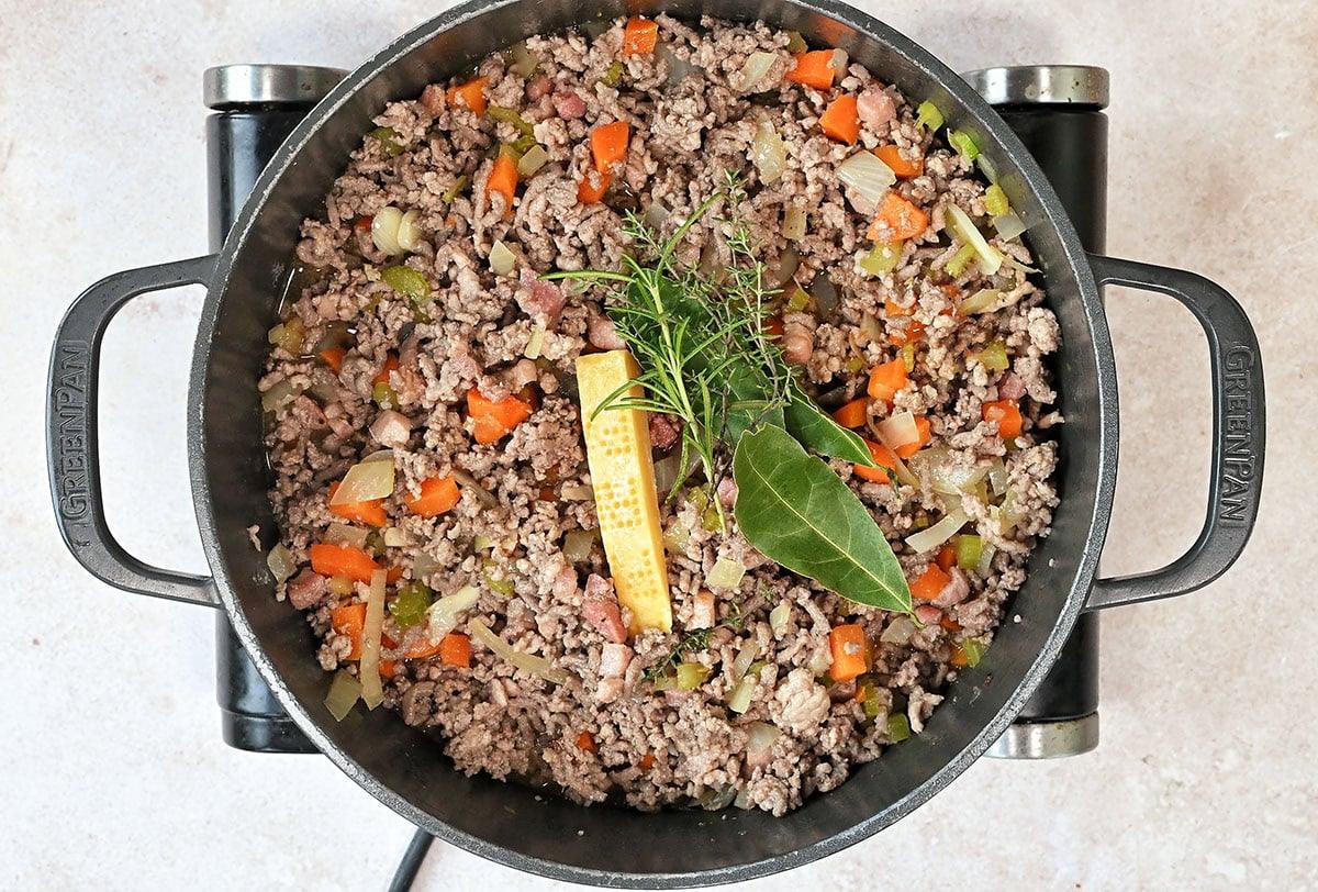 white bolognese sauce cooking in a pot