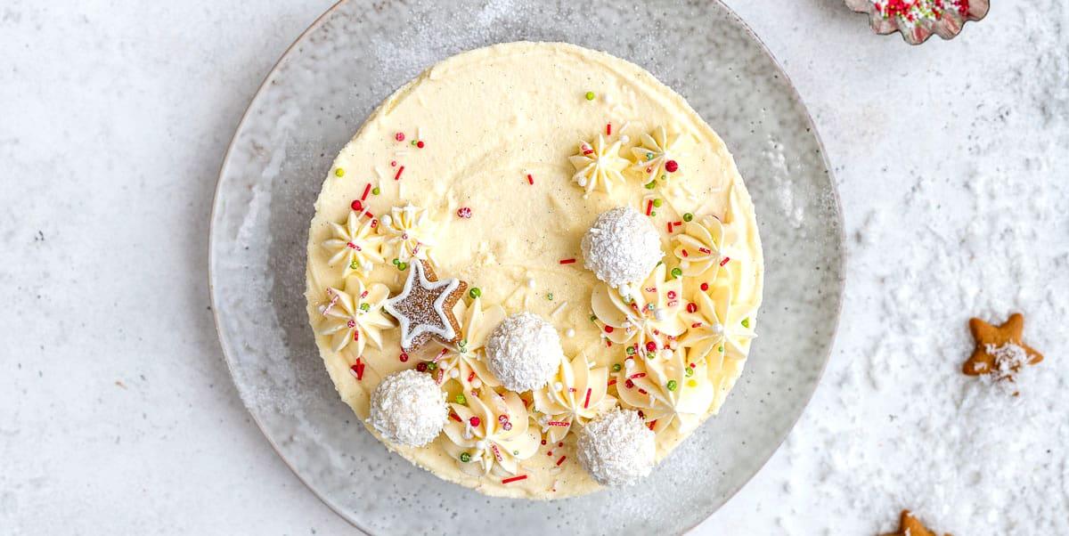 White chocolate cheesecake decorated with fresh cream and white chocolate truffles