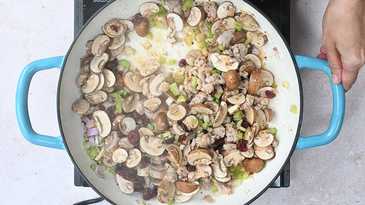 mushrooms, celery, shallots cooking in a skillet